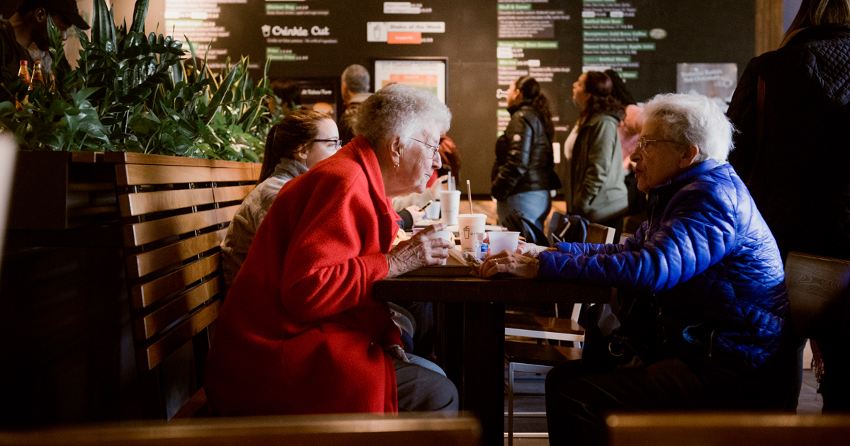 two elderly women talking at shake shack in new haven by Heather Liebensohn of Zen Mantis dot com