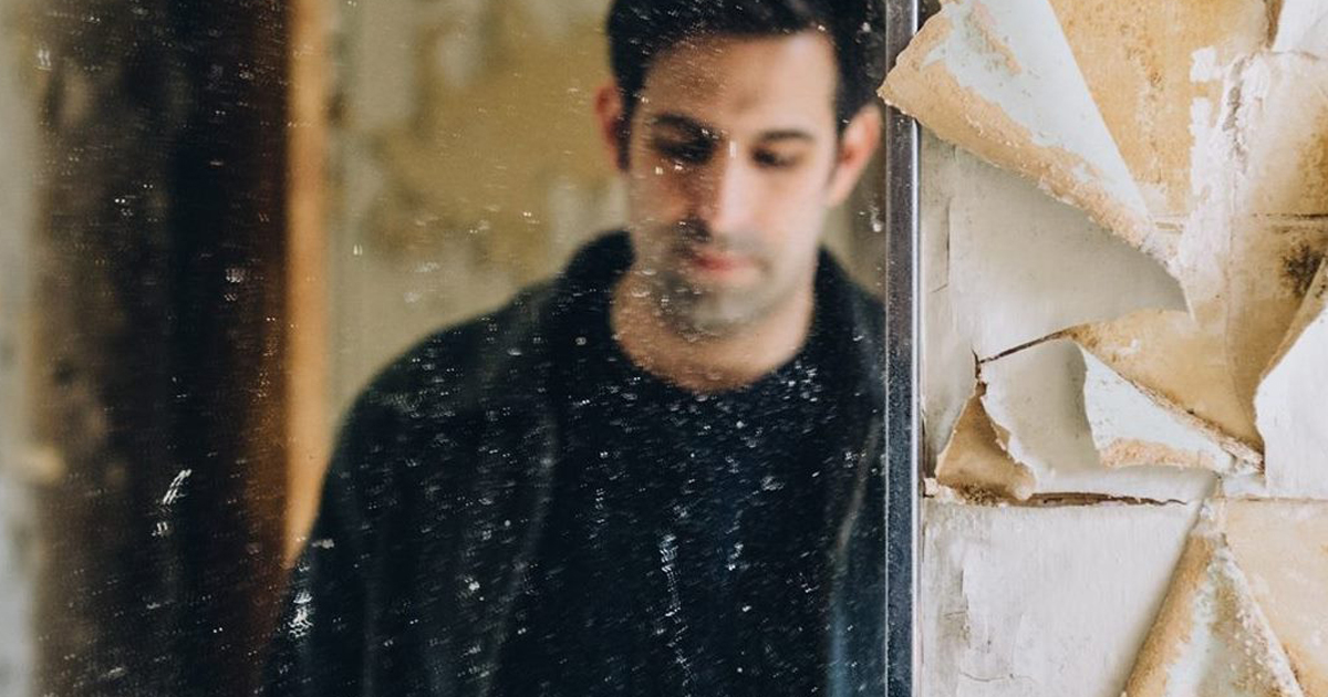 man in mirror in abandoned building by Heather Liebensohn michael defern dot com